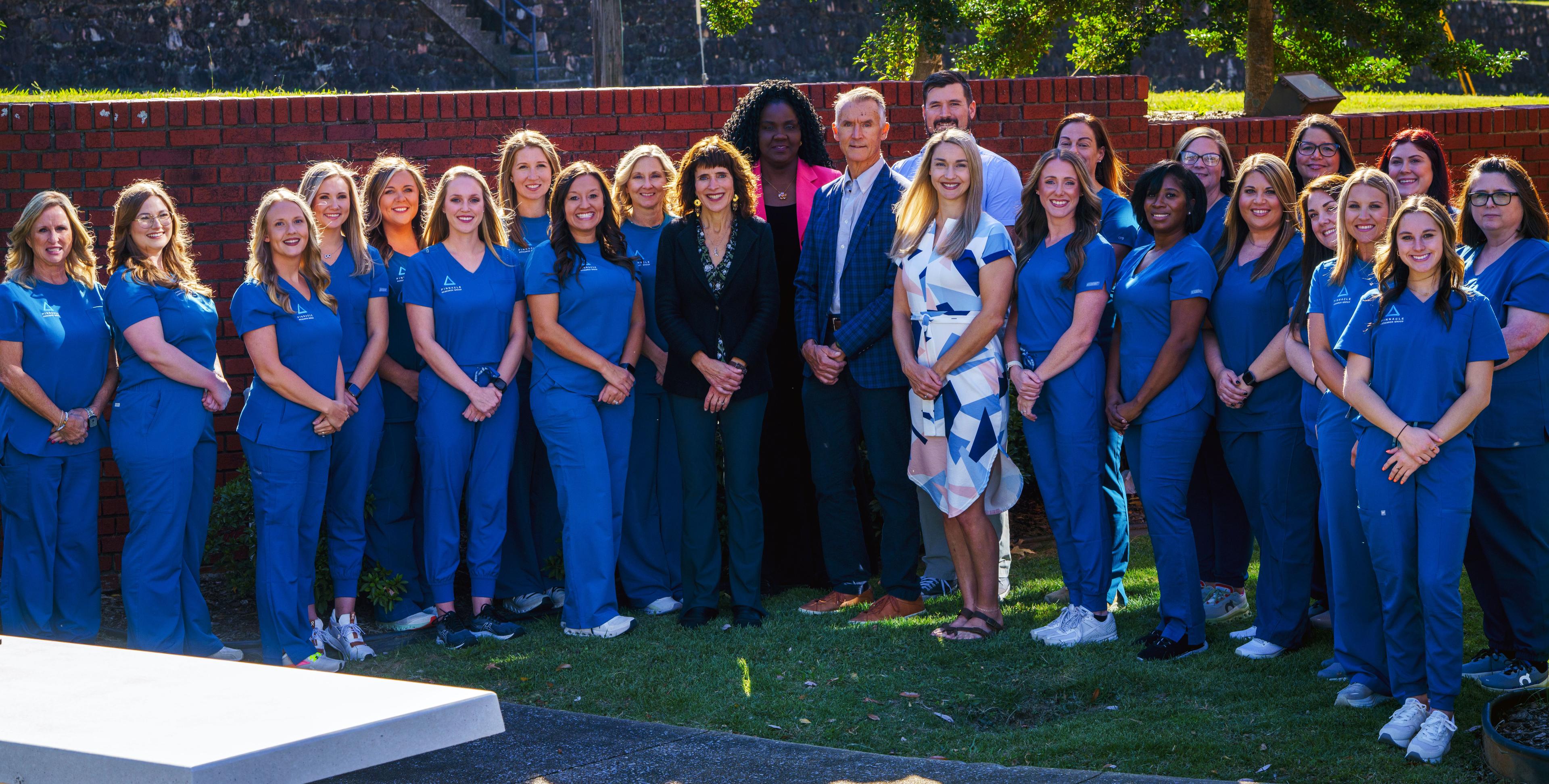 Group photo of nurses and administrators outside of the Pinnacle research building